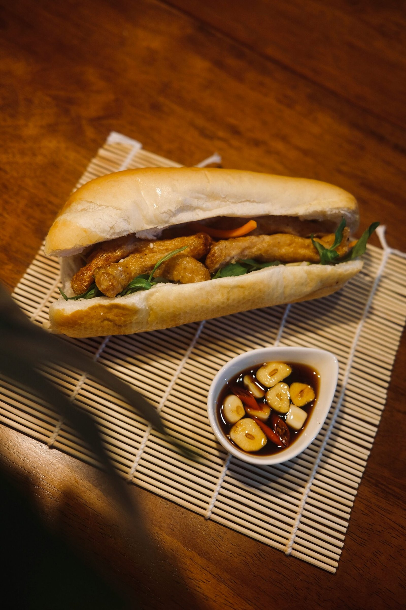 a sandwich and a bowl of food on a table